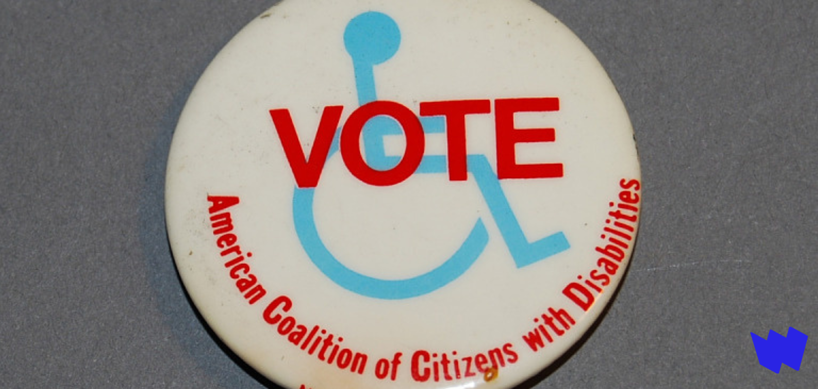 Pin-backed button that says "Vote" over graphic of person in wheelchair. Bottom text says "American Coalition of Citizens with Disabilities."